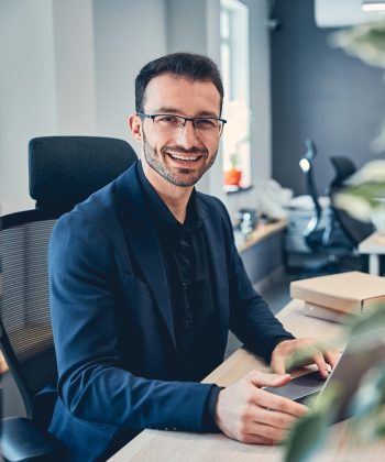 portrait-of-a-smiling-businessman-in-his-office-2021-09-03-15-39-47-utc-e1641646157253.jpg